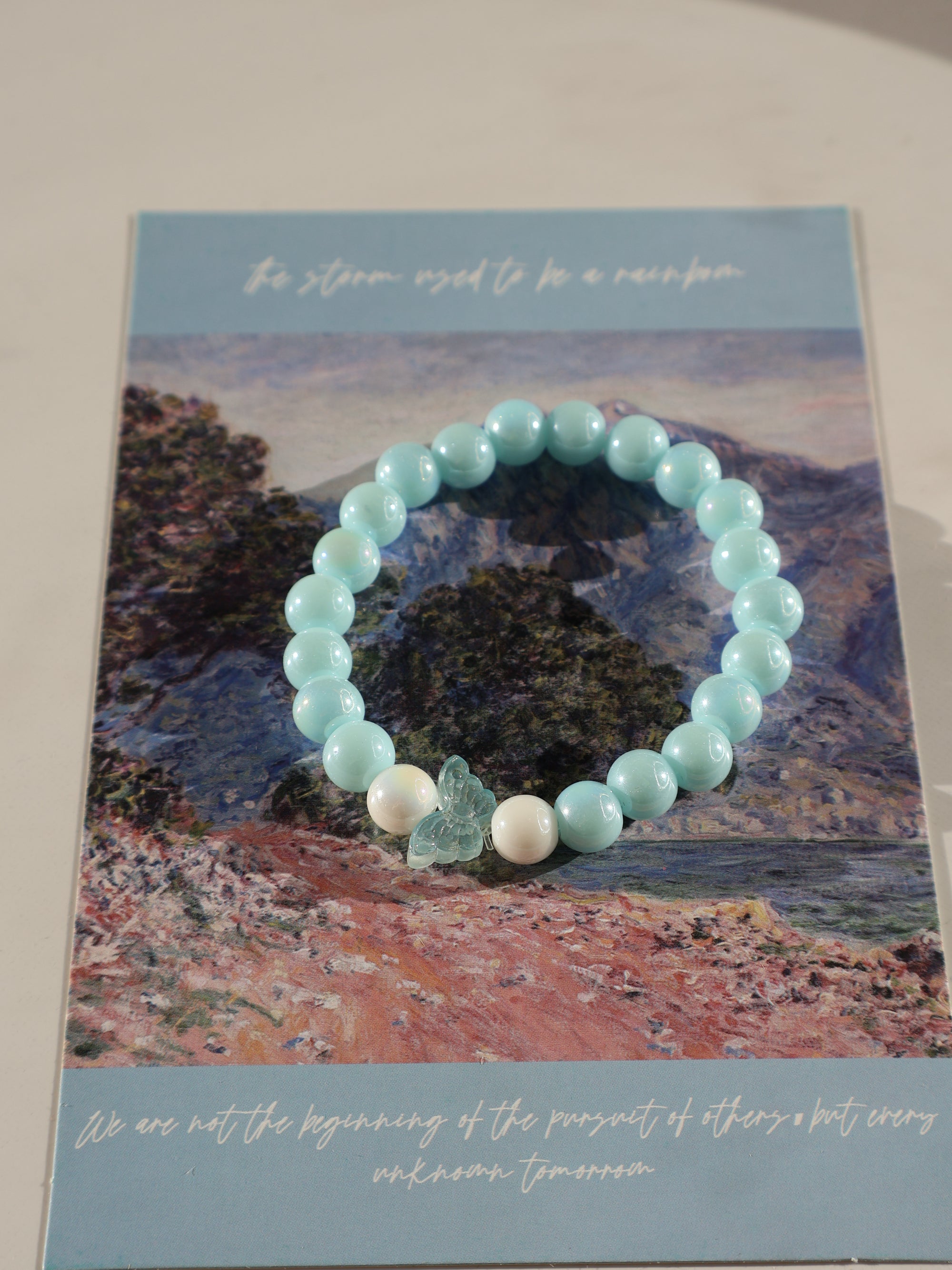 Aqua Blue Glass Beaded Bracelet: Pearl-Like Butterfly Charm